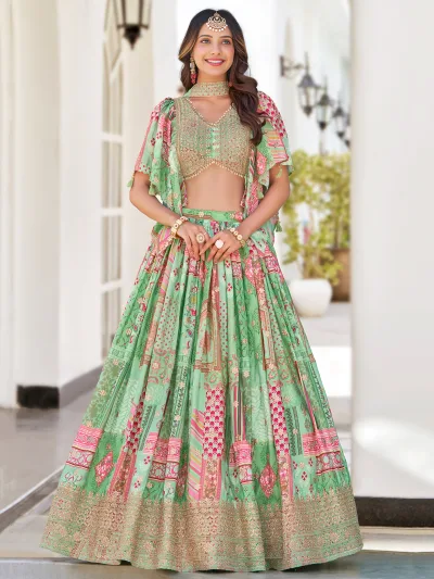 Woman in pastel green multicolor embroidered lehenga with zari border, pearl-detailed blouse, and choker-style dupatta – perfect for weddings and festivals.