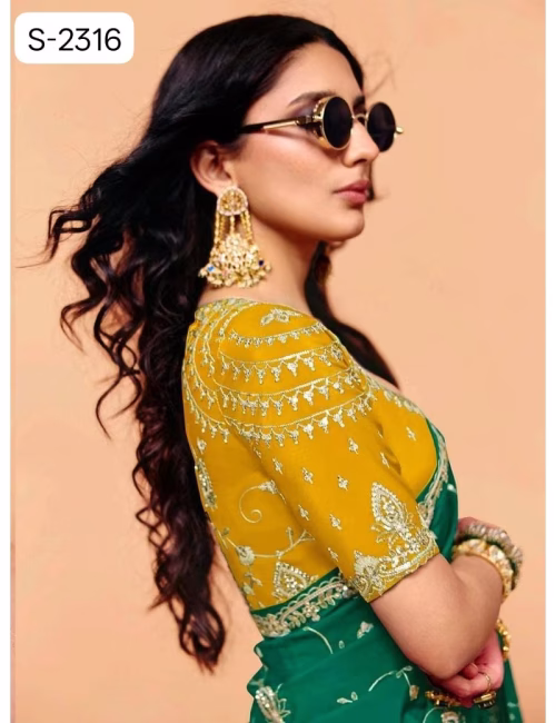 Close-up of designer contrast handwork saree blouse showing a deep V-neck back, heavy silver embroidery, and scalloped sleeve hems.