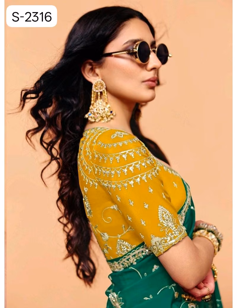 Close-up of designer contrast handwork saree blouse showing a deep V-neck back, heavy silver embroidery, and scalloped sleeve hems.