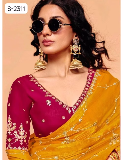 Close-up of designer contrast handwork saree blouse showing a deep V-neck back, heavy silver embroidery, and scalloped sleeve hems. Mustard Yellow