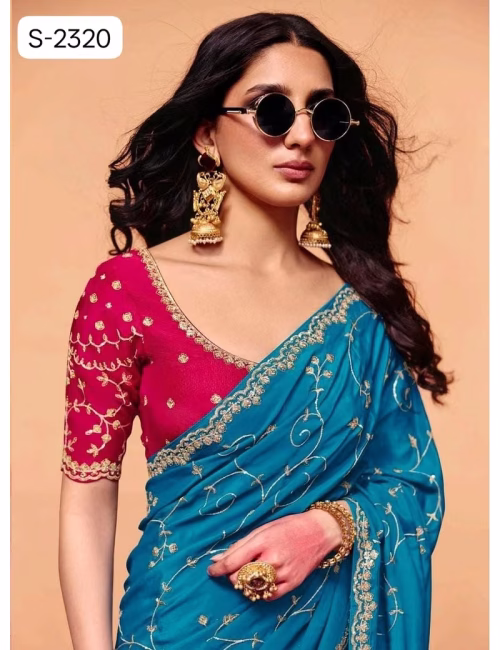 Close-up of designer contrast handwork saree blouse showing a deep V-neck back, heavy silver embroidery, and scalloped sleeve hems.