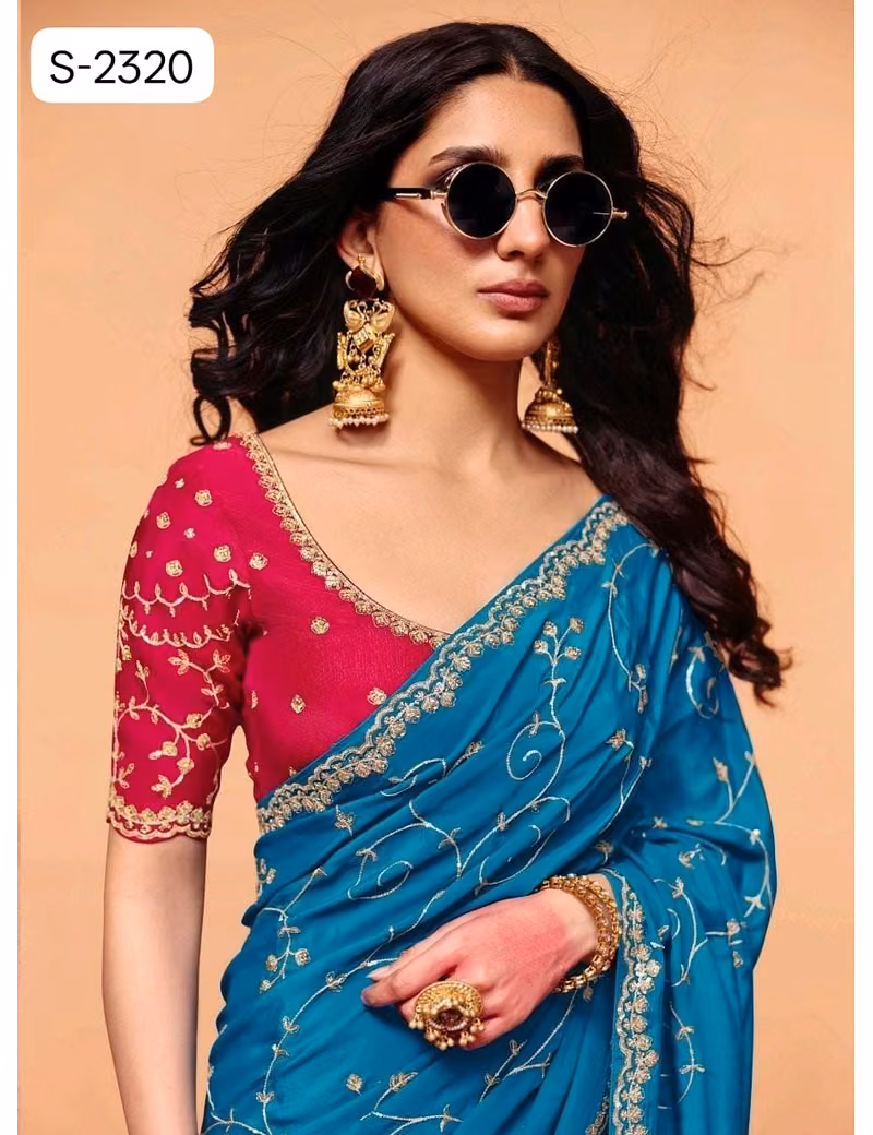 Close-up of designer contrast handwork saree blouse showing a deep V-neck back, heavy silver embroidery, and scalloped sleeve hems.