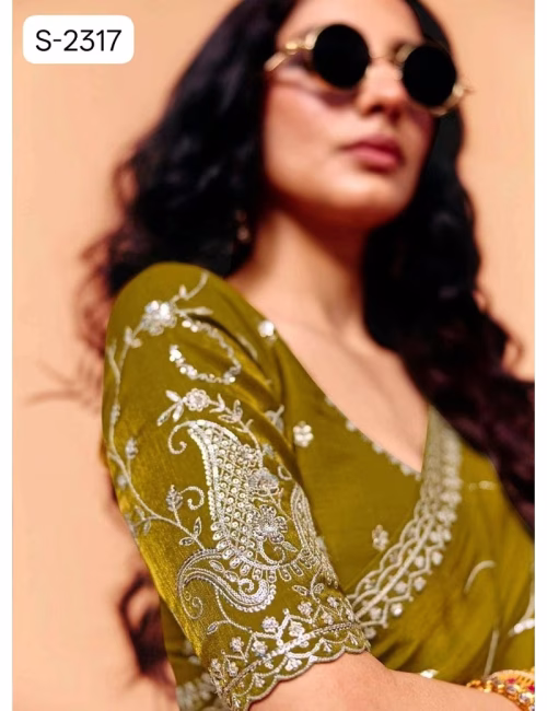 Close-up of designer contrast handwork saree blouse showing a deep V-neck back, heavy silver embroidery, and scalloped sleeve hems.