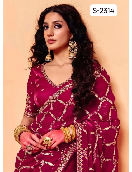Close-up of designer contrast handwork saree blouse showing a deep V-neck back, heavy silver embroidery, and scalloped sleeve hems.